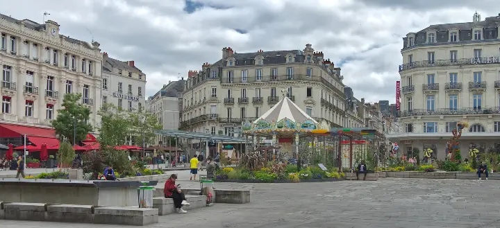 A group of people walking around a city square